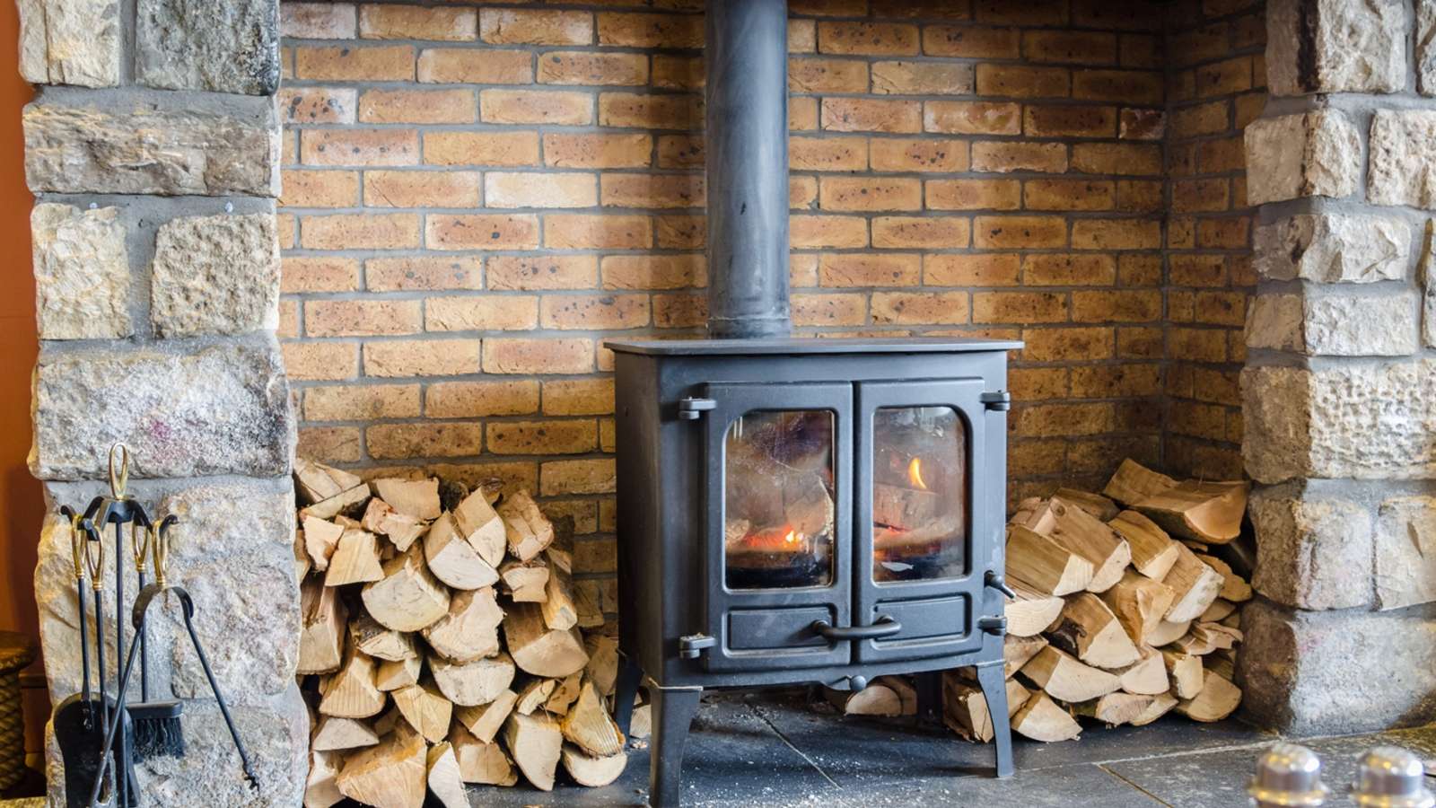 A Wood burner surrounded by wood